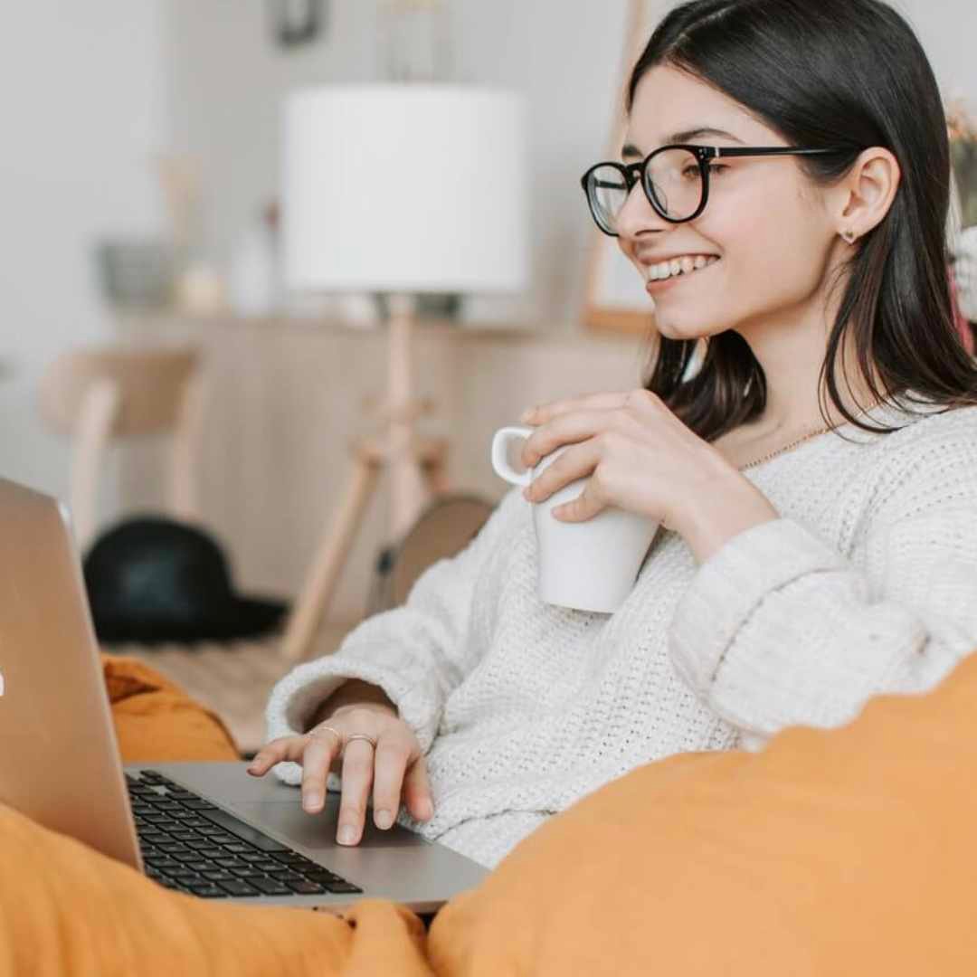 Girl working on laptop drinking coffee