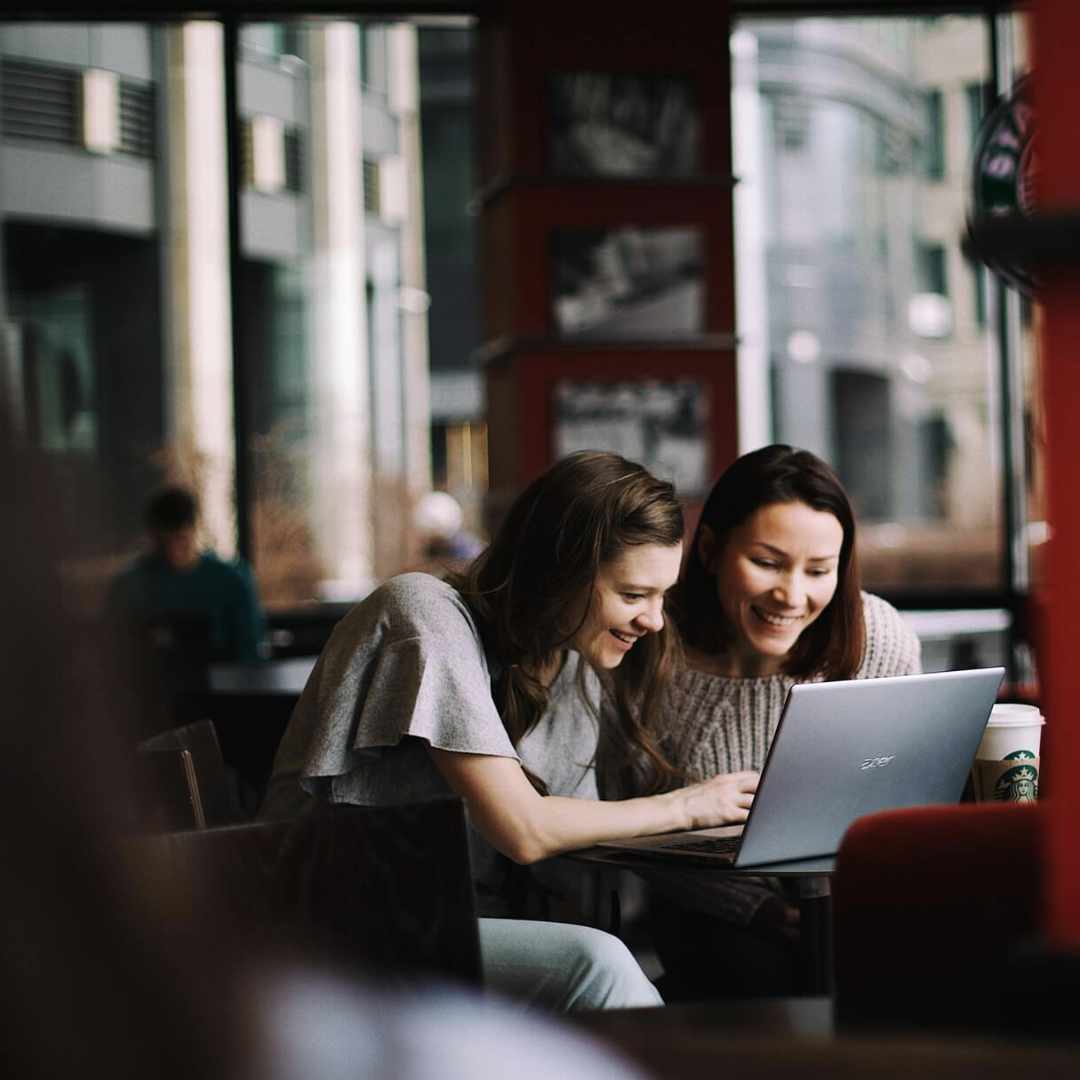 Two girls working at café.